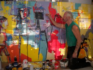 Artist Paul Ygartua painting in studio